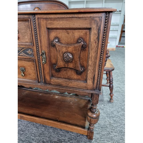 486 - A good quality solid oak antique ornate sideboard with two doors to the side and two drawers to the ... 