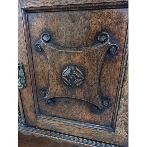 486 - A good quality solid oak antique ornate sideboard with two doors to the side and two drawers to the ... 