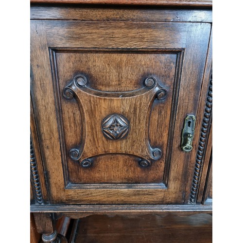 486 - A good quality solid oak antique ornate sideboard with two doors to the side and two drawers to the ... 