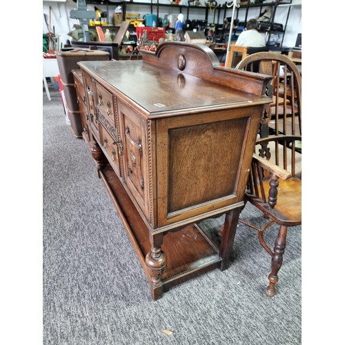 486 - A good quality solid oak antique ornate sideboard with two doors to the side and two drawers to the ... 