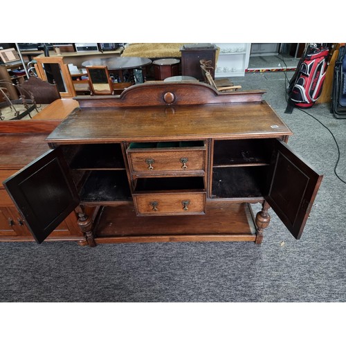 486 - A good quality solid oak antique ornate sideboard with two doors to the side and two drawers to the ... 