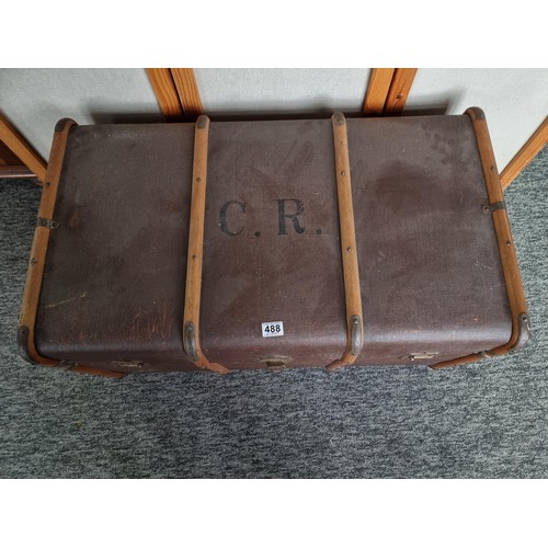 488 - Large wood bound travellers trunk in good order stamped C.R. to the top in good overall condition wi... 