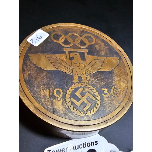 176 - A reproduction Third Reich brass compass with a screw off lid and having Third Reich graphics to the... 