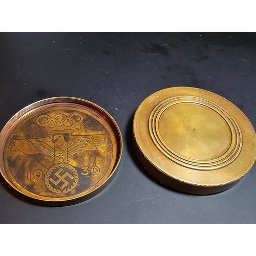 176 - A reproduction Third Reich brass compass with a screw off lid and having Third Reich graphics to the... 