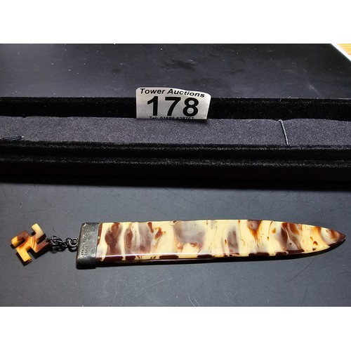 178 - An unusual early 20th century celluloid bookmark having a sterling silver mount suspending a cellulo... 