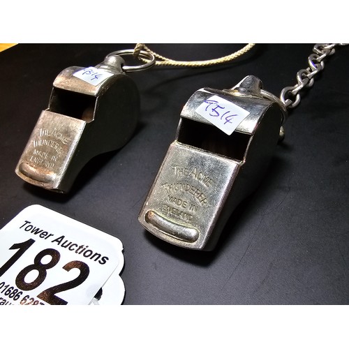 182 - 2x vintage the Acme thunderer police whistles, 1 with a metal chain the other with a rope, both in g... 