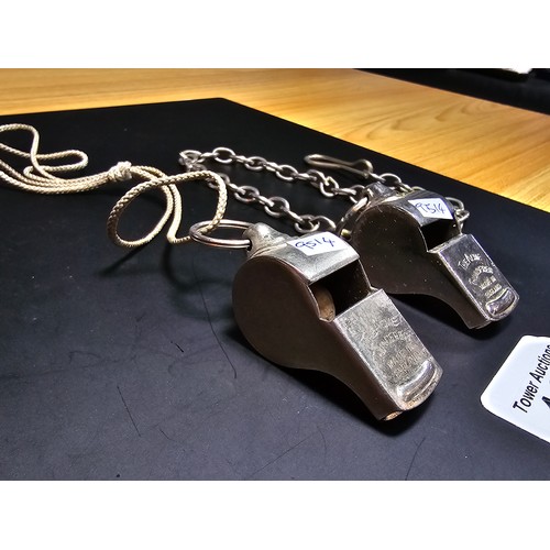 182 - 2x vintage the Acme thunderer police whistles, 1 with a metal chain the other with a rope, both in g... 