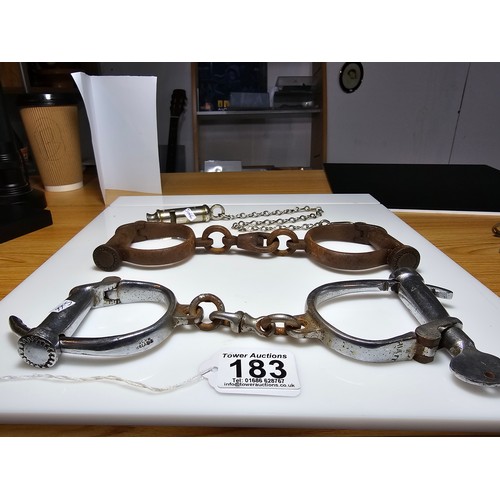 183 - A selection of police related items which includes a pair of vintage chrome handcuffs by Hiatt compl... 