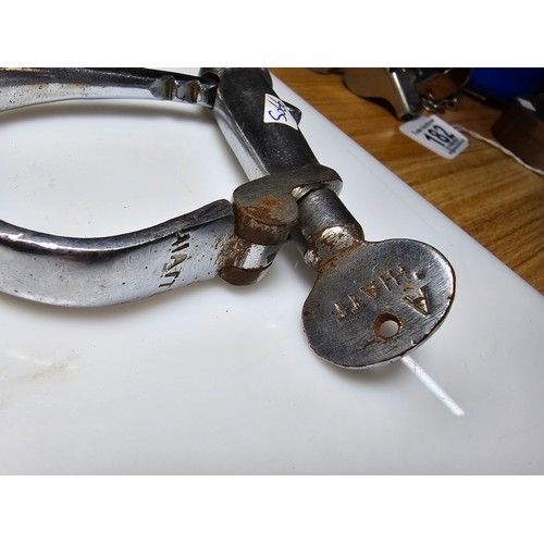 183 - A selection of police related items which includes a pair of vintage chrome handcuffs by Hiatt compl... 