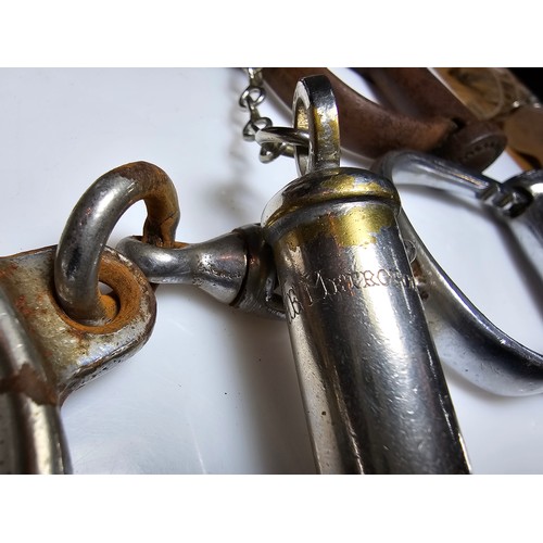 183 - A selection of police related items which includes a pair of vintage chrome handcuffs by Hiatt compl... 