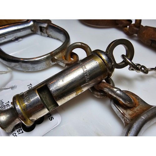 183 - A selection of police related items which includes a pair of vintage chrome handcuffs by Hiatt compl... 