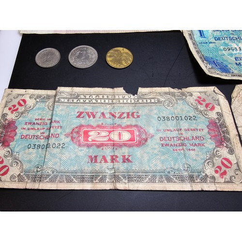 185 - A quantity of German wartime banknotes and coins along with 2 British £1 notes and a 10 shilling not... 