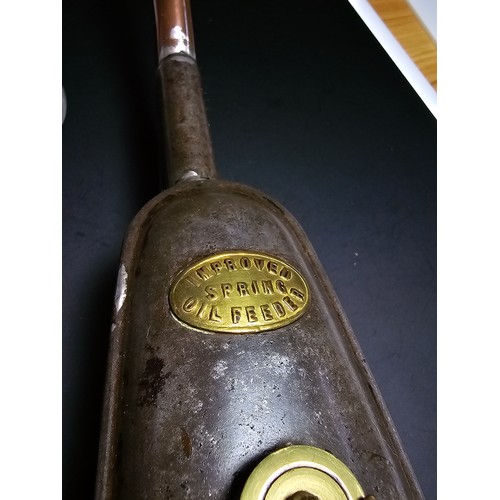 187 - An attractive antique Victorian oil can, improved spring oil feeder along with an antique pipette. T... 