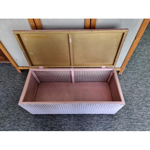 498 - Lloyd loom stamped upholstered ottoman with pink material top in good order measures 35cm high  87cm... 