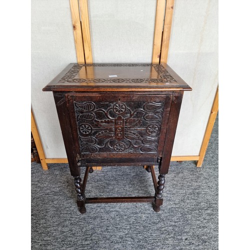 511 - Antique highly carved drinks cabinet with tulip carving to the front and sides, has a pair of pullou... 