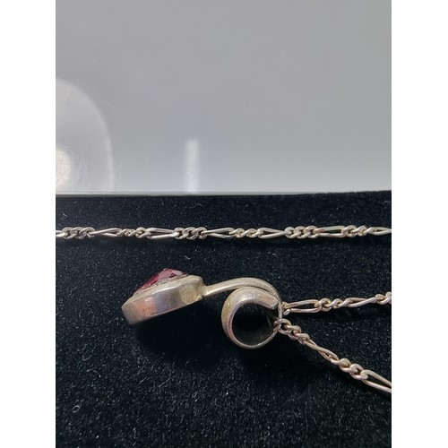 249 - A 925 silver teardrop formed pendant inset with almandine garnet set on an 18