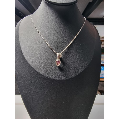 249 - A 925 silver teardrop formed pendant inset with almandine garnet set on an 18