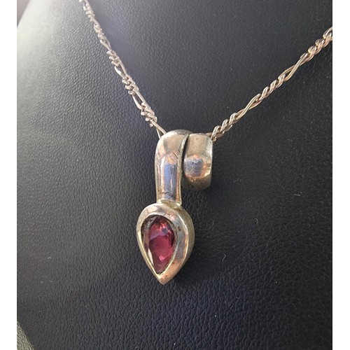 249 - A 925 silver teardrop formed pendant inset with almandine garnet set on an 18