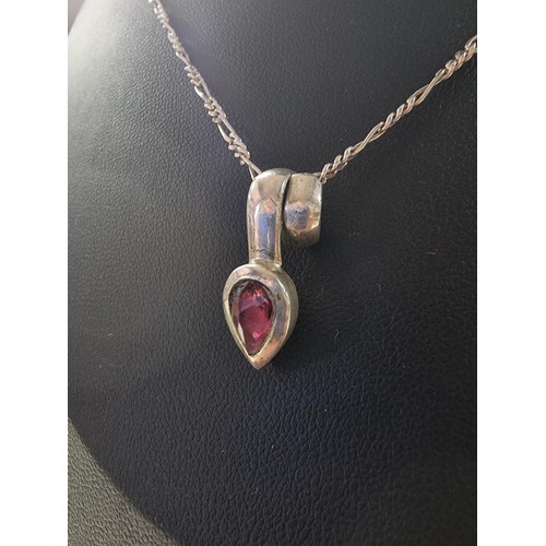 249 - A 925 silver teardrop formed pendant inset with almandine garnet set on an 18