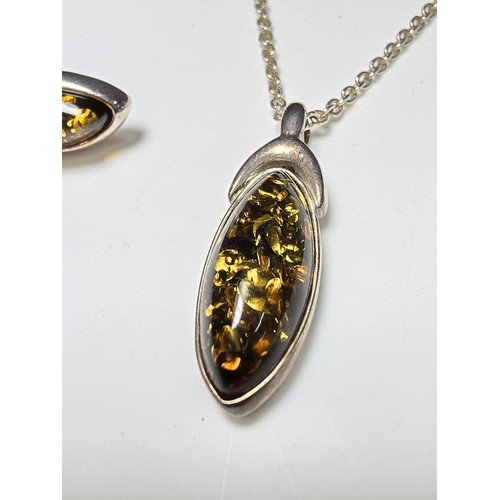 244 - A pretty matching unused 925 silver amber jewellery set which includes a pendant, necklace and stud ... 