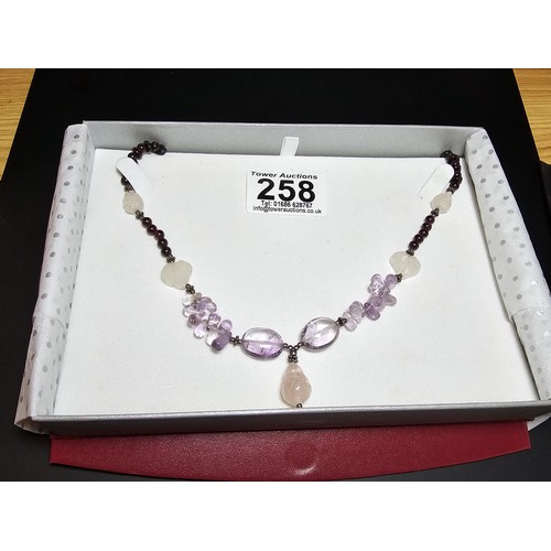 258 - A good quality semi precious stone beaded necklace which features a rose quartz carved drop, amethys... 