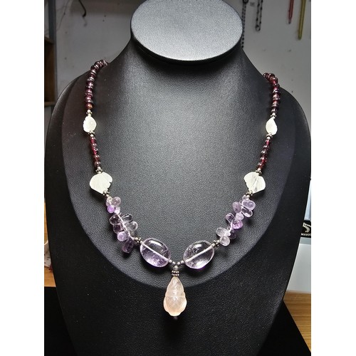 258 - A good quality semi precious stone beaded necklace which features a rose quartz carved drop, amethys... 