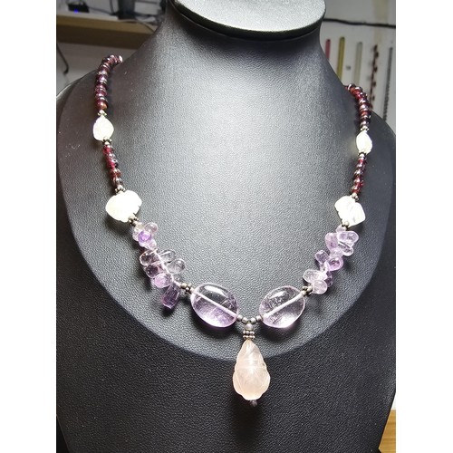 258 - A good quality semi precious stone beaded necklace which features a rose quartz carved drop, amethys... 