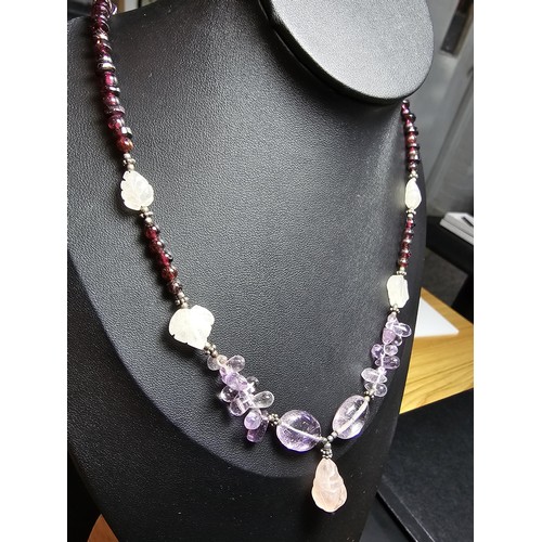 258 - A good quality semi precious stone beaded necklace which features a rose quartz carved drop, amethys... 