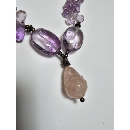 258 - A good quality semi precious stone beaded necklace which features a rose quartz carved drop, amethys... 