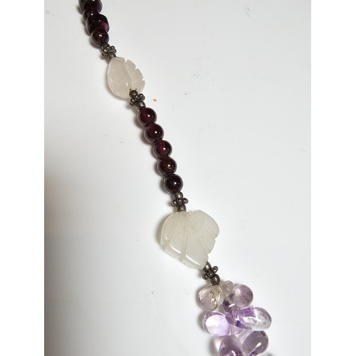 258 - A good quality semi precious stone beaded necklace which features a rose quartz carved drop, amethys... 