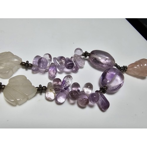 258 - A good quality semi precious stone beaded necklace which features a rose quartz carved drop, amethys... 