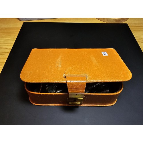 259 - A vintage leather jewellery box containing a quantity of costume jewellery which includes 2 good ver... 