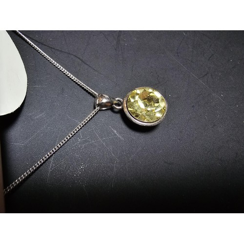 262 - A pretty as new 925 silver pendant inset with a yellow CZ stone on an 18