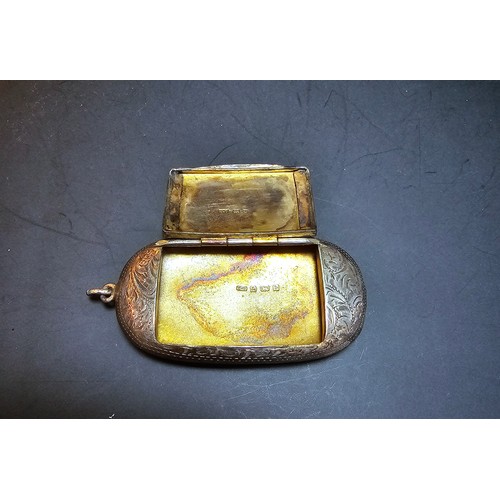 265 - A good quality antique hallmarked silver Vesta case of oblong shape having an ornate engraved design... 