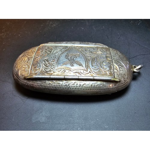 265 - A good quality antique hallmarked silver Vesta case of oblong shape having an ornate engraved design... 