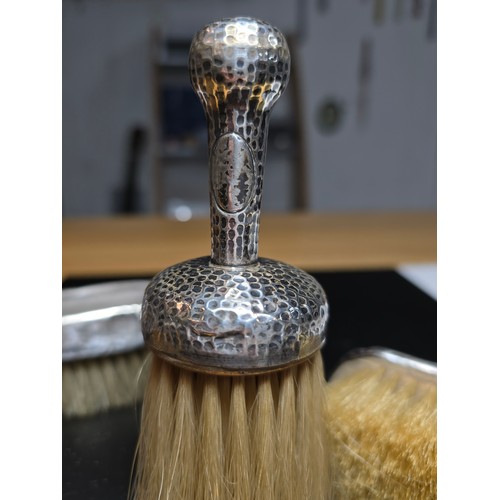 271 - 2x hallmarked silver backed clothes brushes along with a hand hammered white metal handled brush, ap... 