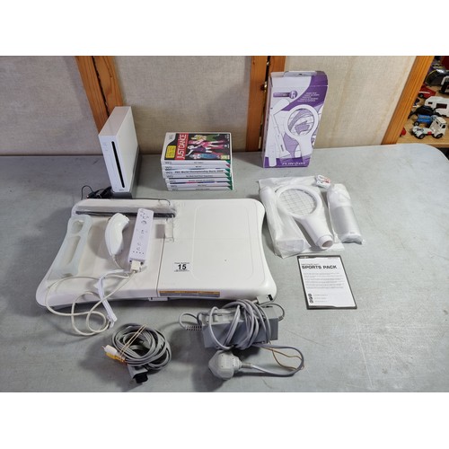 15 - A Nintendo Wii console including controllers (including an as new Wiimote), 7 games, sports racket c... 