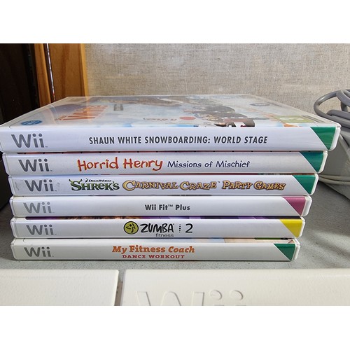 16 - Nintendo Wii console in black with a quantity of Wii Games, Wii Fit board etc