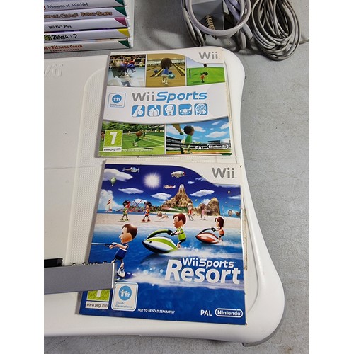 16 - Nintendo Wii console in black with a quantity of Wii Games, Wii Fit board etc