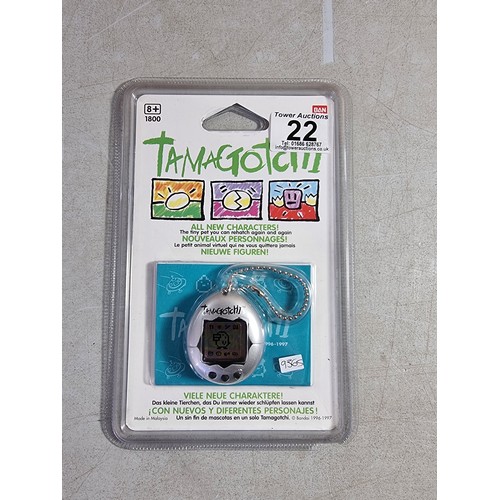 22 - A Bandai Tamagotchi in its sealed case, dated 1996 - 1997