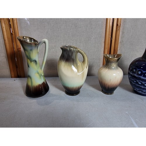 78 - Collection of collectable vases inc a West German vase, double horned vase, 3x cream and brown vases... 