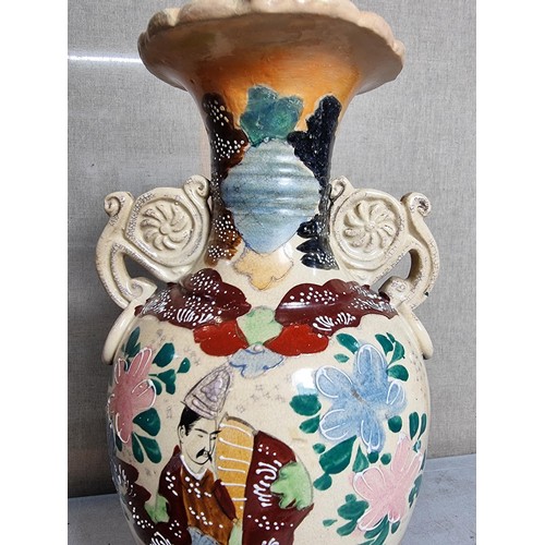 72 - Pair of ornate vases with scroll design to the handles, with oriental designs stands at 39cm high