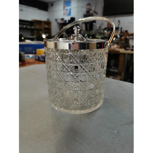 167 - A silver plated biscuit barrel in cut glass with lid along with a large Livivo champagne bucket all ... 