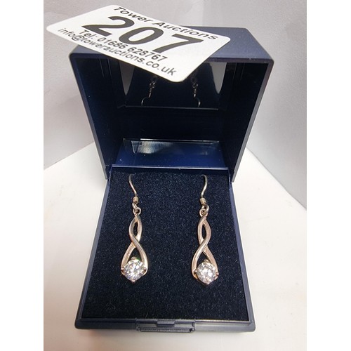 207 - Hallmarked 925 silver figure of 8 shaped drop earrings inset with large CZ stones which are very spa... 