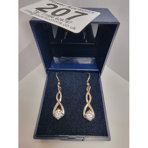 207 - Hallmarked 925 silver figure of 8 shaped drop earrings inset with large CZ stones which are very spa... 