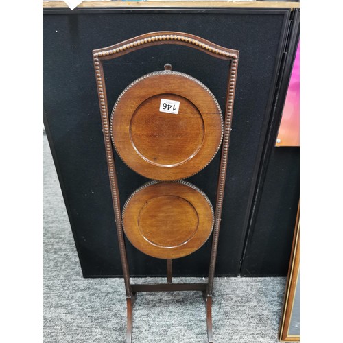 146 - 2 tier mahogany foldable wooden display stand in good order with beading decoration to the edges all... 