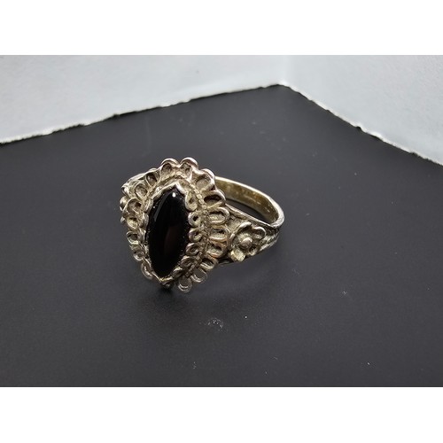 220 - A good vintage 925 sliver ring with an ornate design inset with a black onyx stone in good clean con... 