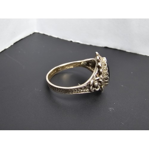 220 - A good vintage 925 sliver ring with an ornate design inset with a black onyx stone in good clean con... 