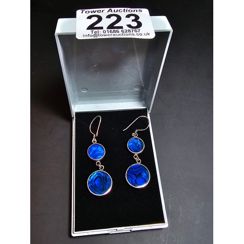 223 - A pair of pretty 925 silver long drop earrings inset with colourful blue abalone shell which is doub... 