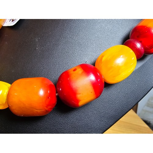 172 - A large and impressive vintage early plastic amber style large beaded necklace presenting excellent ... 
